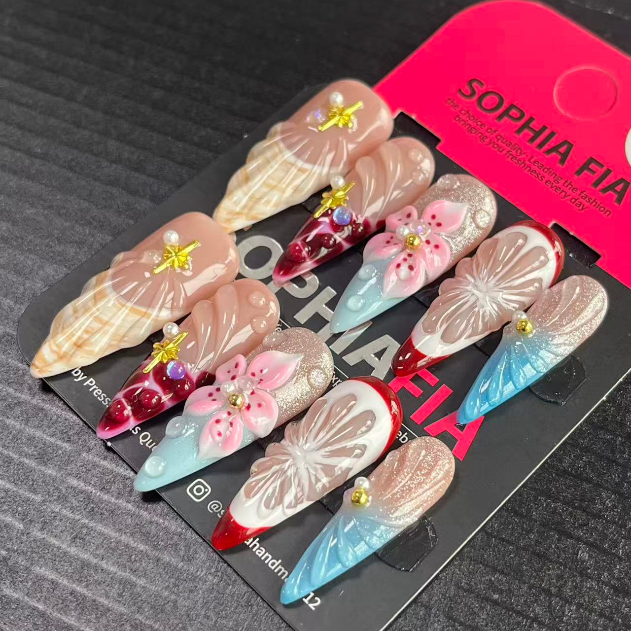 Press On Nails Long Coffin Beach‑Inspired Style - Nude Base Seashell Texture, Blue‑Red Glitter Ombre French Tip, 3D Pink Flower, Butterfly Print, Gold Star Charms, Pearl & AB Iridescent Rhinestone Acrylic Nail Tips